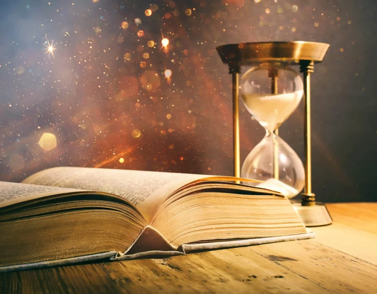 antique book on wooden table with bright light AdobeStock_469662016