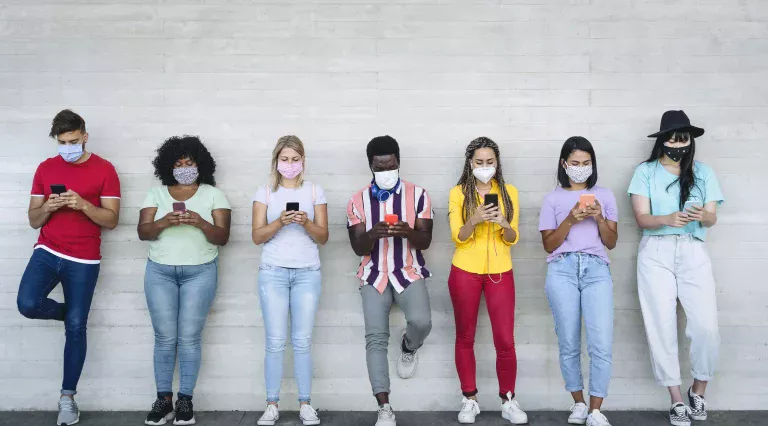 Young people wearing face mask using mobile smartphone outdoor AdobeStock_362342671 0450